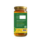 Jar of honey with a green label on a white background