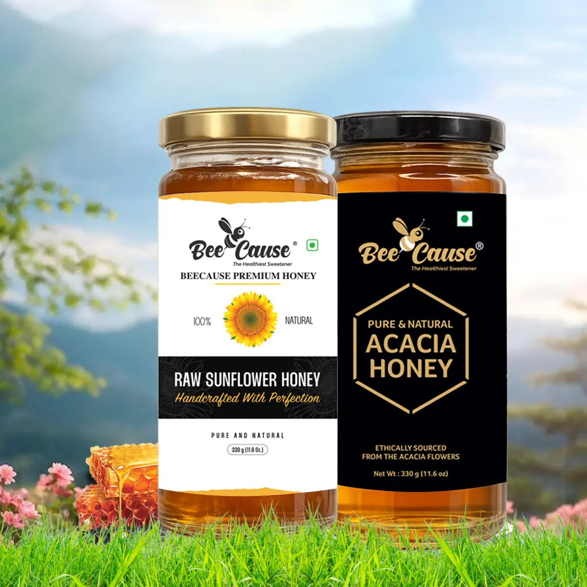 Two jars of Bee Cause premium honey placed in bright green grass with honeycomb and mountains in the background. The left jar is Raw Sunflower Honey, and the right jar is Pure & Natural Acacia Honey.