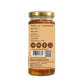 Jar of honey with a gold lid and label on a white background