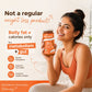 A woman in an orange sports bra holds a jar of Dr. Vaidya's Skimmed Milk powder.