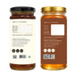 Two amber glass supplement bottles shown side by side, displaying the back labels of a product. The left bottle has a black lid and a cream label, while the right bottle has a gold lid and a brown label.