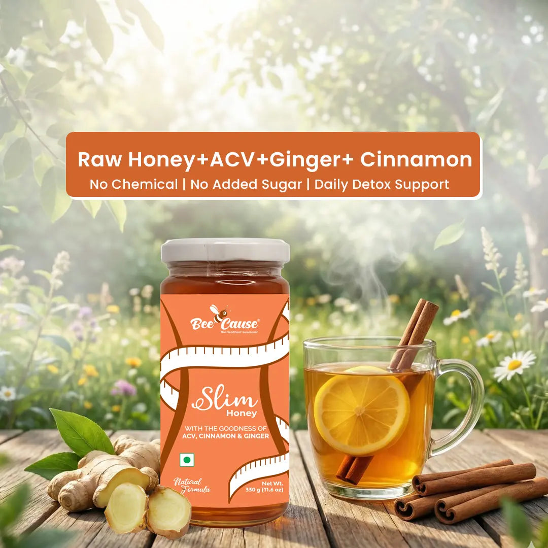 A jar of Bee Cause Slim Honey placed on a wooden table next to a hot mug of tea with a lemon slice and cinnamon sticks, surrounded by raw ginger and a sunny garden background. A banner reads "Raw Honey + ACV + Ginger + Cinnamon | No Chemical | No Added Sugar | Daily Detox Support".