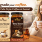 Two jars of Bee Cause Brew Nectar coffee flavor syrups (Honey & Vanilla and Honey & Maple) displayed on a wooden table next to a woman holding a cup of coffee in a cozy cafe setting.