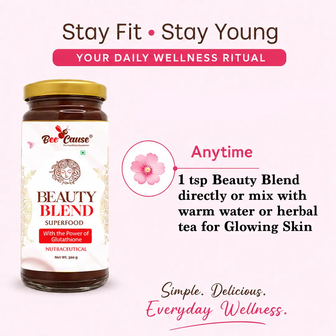 A jar of Bee Cause Beauty Blend Superfood on a light pink background with promotional text. The product has a white label, gold lid, and dark brown contents, with text describing it as a daily wellness ritual and usage instructions.