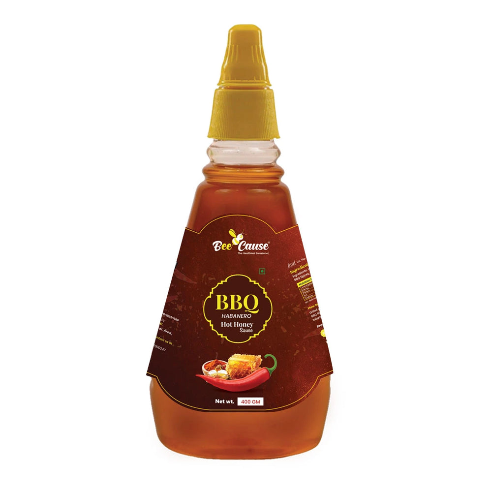 Bottle of Bee Cause BBQ sauce with a yellow cap on a white background