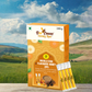 A 240-gram box of Bee Cause Masala Chai Flavoured Honey Zips and four individual honey sticks placed on a wooden surface against a picturesque background of green hills and a partly cloudy blue sky.