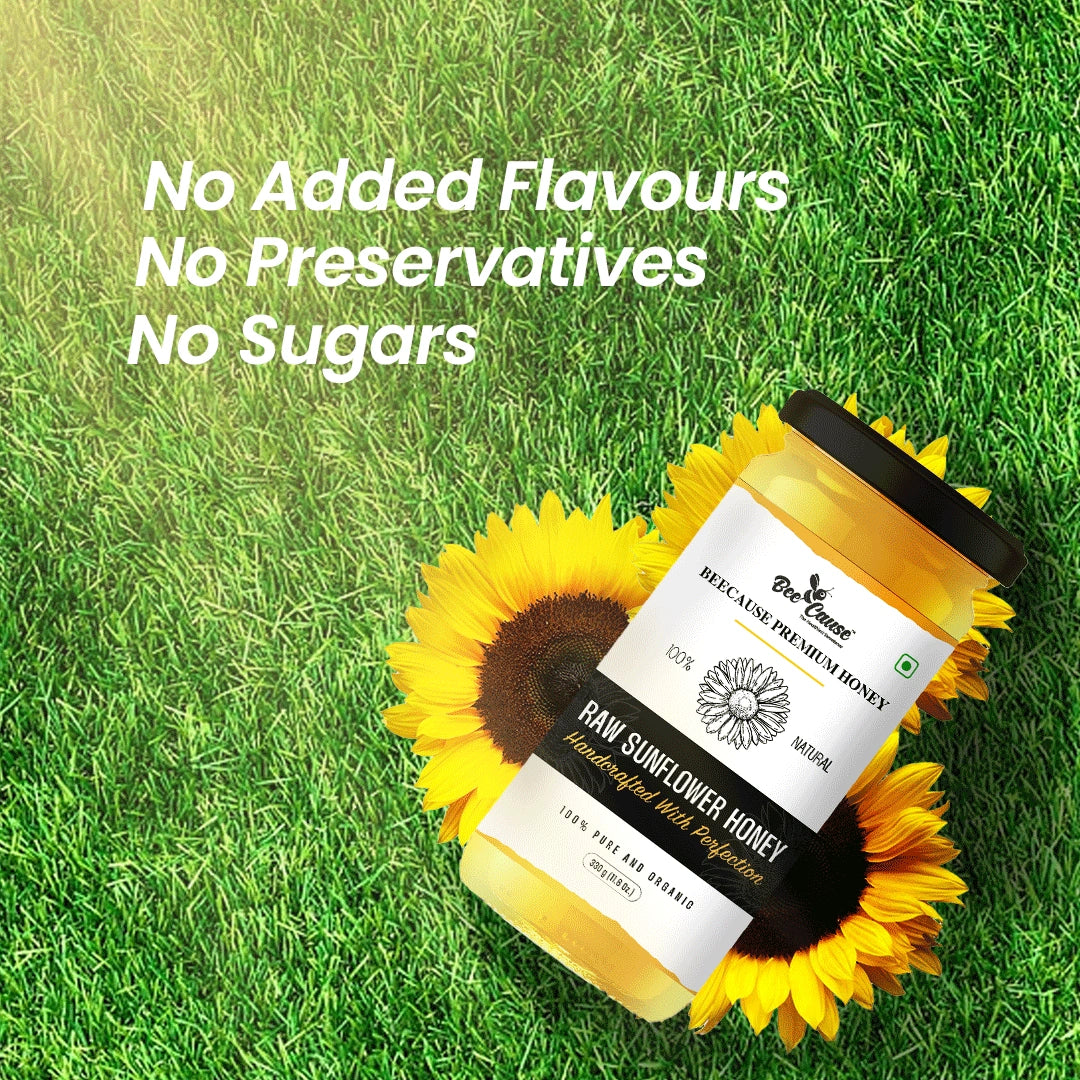 Bee Cause Raw Sunflower Honey displayed on green grass with sunflowers, highlighting key purity claims: "No Added Flavours," "No Preservatives," and "No Sugars".