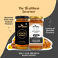Two jars of Bee Cause premium honey displayed side by side on a stylized beige and dark gray background with promotional text. The left jar is labeled Pure & Natural Acacia Honey with a black label and black lid, and the right jar is labeled Raw Golden Honey with a beige label and gold lid.