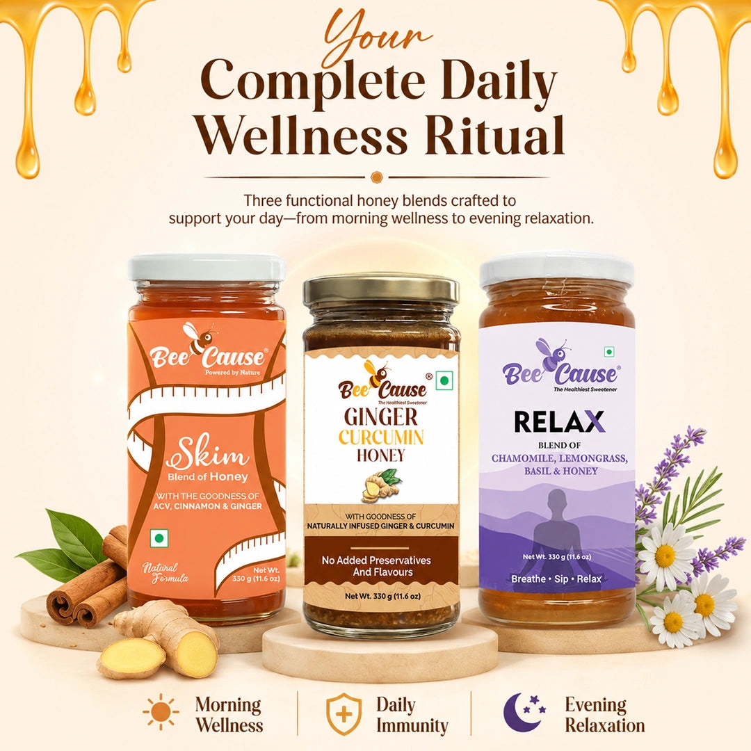 Three jars of Bee Cause wellness honey blends are displayed on a wooden stand against a warm cream background with decorative honey drips and flowers. The jars are labeled Slim (orange), Ginger Curcumin Honey (brown), and Relax (lavender).