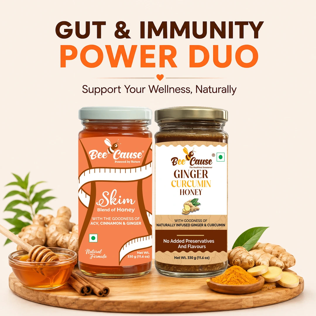 Two jars of Bee Cause wellness products displayed on a wooden board with ginger, honey, cinnamon, and turmeric, under the headline 'GUT & IMMUNITY POWER DUO'. The left jar is Skim Blend of Honey, and the right jar is Ginger Curcumin Honey.