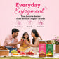 A lifestyle advertisement featuring a family picnic scene with two adults and a child holding a drink, set against a pink background with promotional text. In the foreground, two jars of Brij Bhawan Honey are displayed: 'Home Honey' in pink packaging and 'Paan Honey' in green packaging, with fresh fruits like strawberries, grapes, and oranges on a picnic blanket.