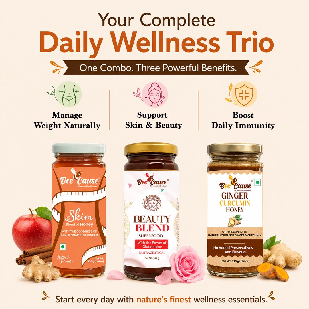 Promotional graphic for a Bee Cause Daily Wellness Trio, featuring three jars of honey and supplements: Skim Honey, Beauty Blend Superfood, and Ginger Cucumber Honey. The image includes descriptive text and icons highlighting benefits like weight management, skin/beauty support, and immune boosting, with decorative fruits and flowers on a light beige background.