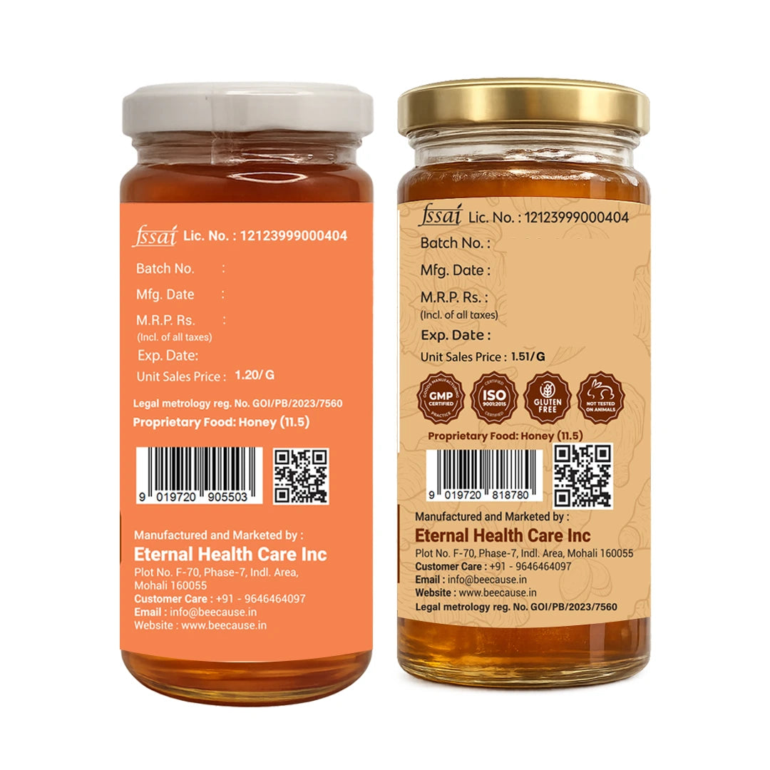 Two glass jars of honey shown side by side on a white background, displaying the front and back labels of the product. The honey inside is a rich amber-brown color, and the labels are orange and beige respectively, with white and gold lids.