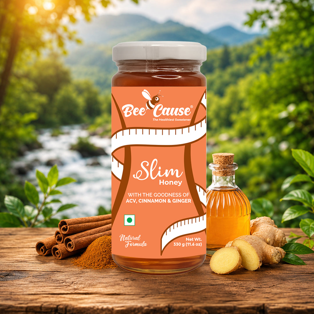 Jar of 'Bee Cause' Slim Honey with cinnamon sticks and ginger on a wooden surface with a natural background