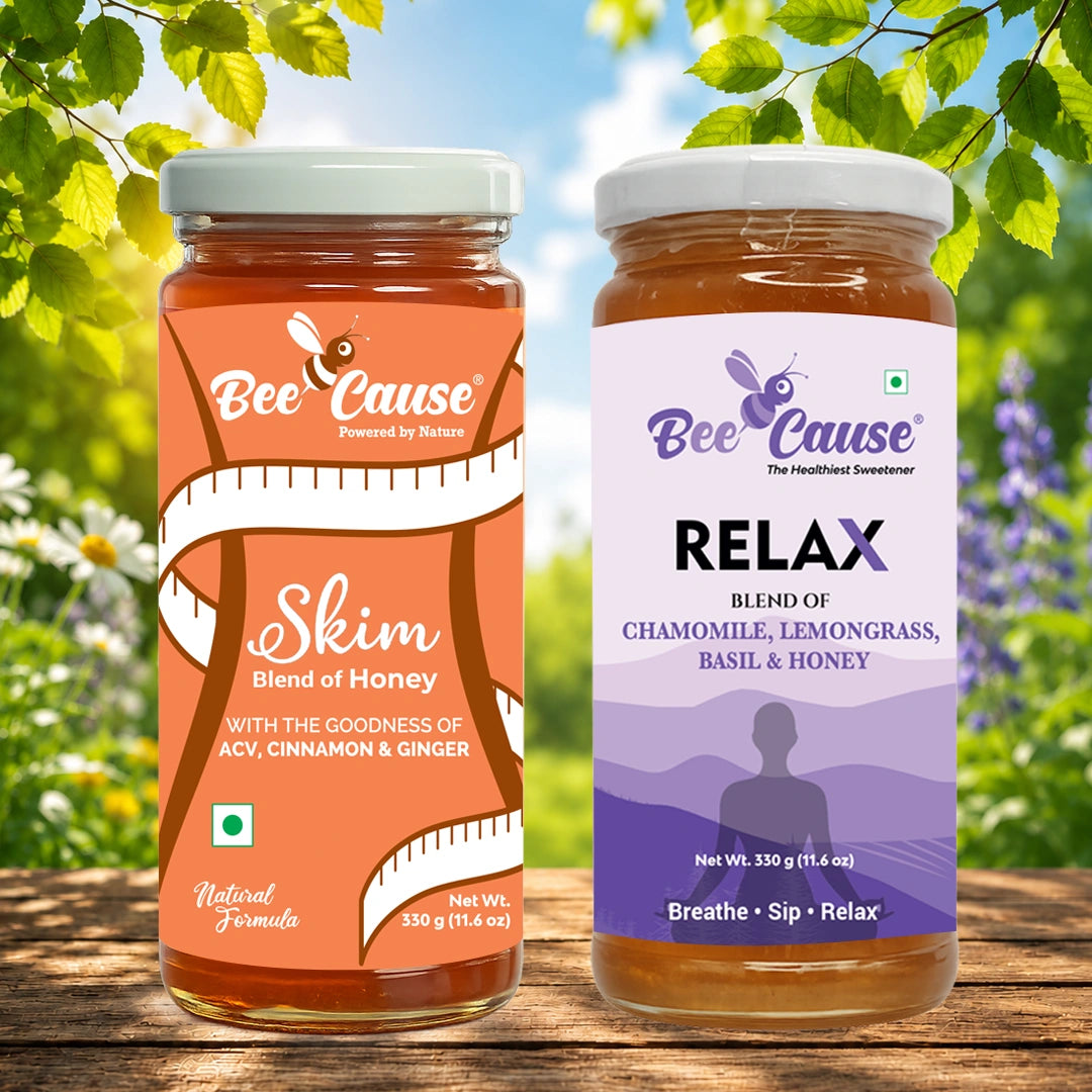 Two jars of Bee Cause honey products displayed side by side on a wooden surface with a blurred garden background. The left jar is labeled 'Skim Blend of Honey' in orange and white, and the right jar is labeled 'RELAX' in purple and white.