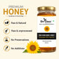 A jar of Bee Cause Raw Sunflower Honey on a light beige background with promotional text and icons. The jar has a gold lid and a white label with a sunflower graphic.