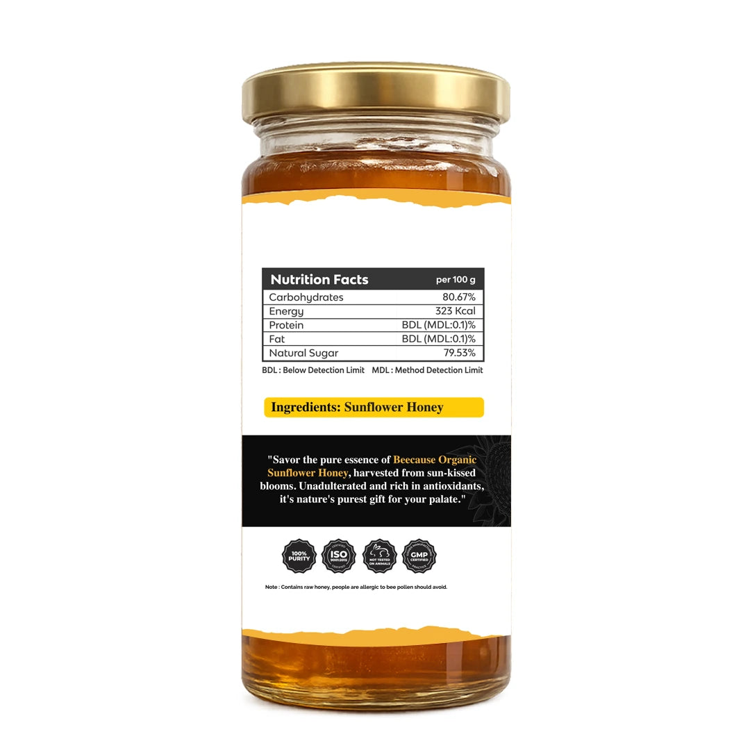 Jar of honey with a gold lid on a white background
