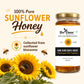 Jar of sunflower honey with sunflowers and branding on a light background